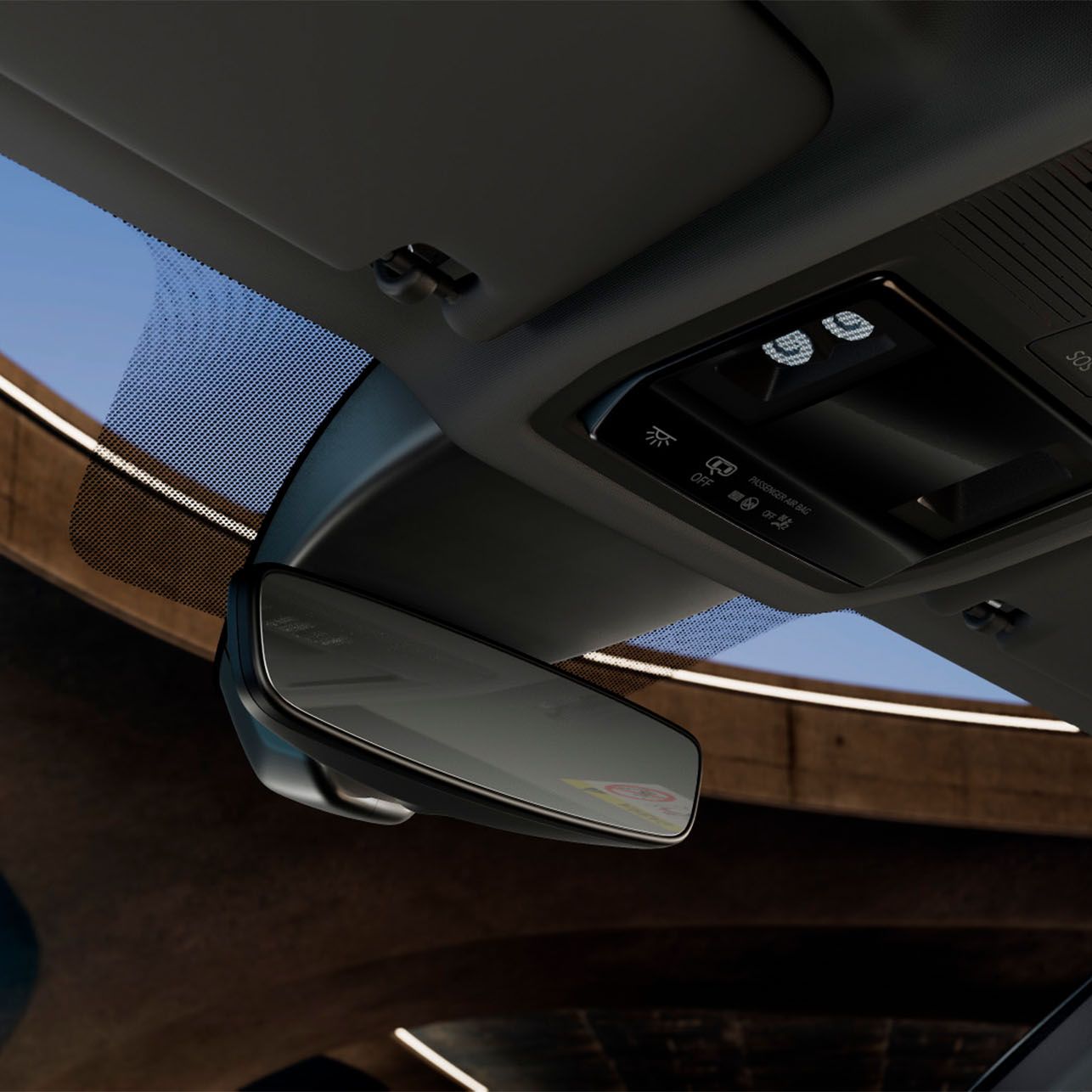 Pogled na strop avtomobila Cupra Formentor z vzvratnim ogledalom, vklopljenimi lučmi in opozorilnim znakom na vizirju. 